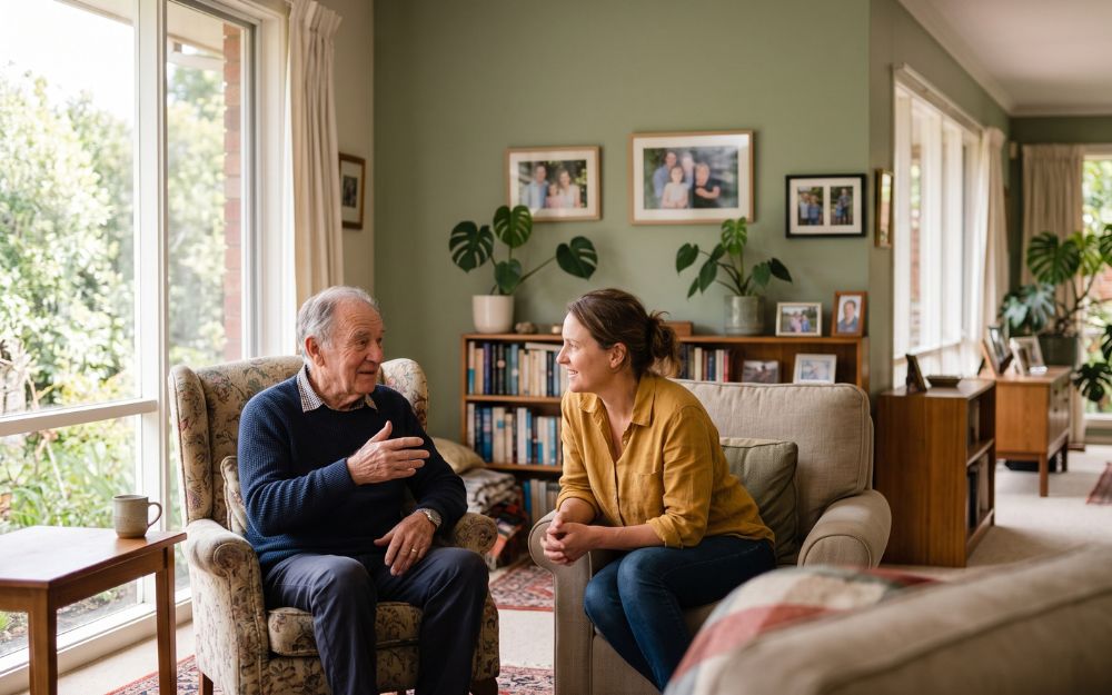 Elderly man in a clear, engaged conversation with his daughter at home, illustrating testamentary capacity and the ability to make a valid Will